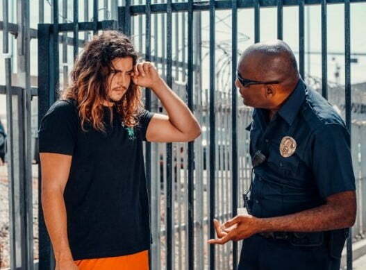 A man in black shirt and a cop.