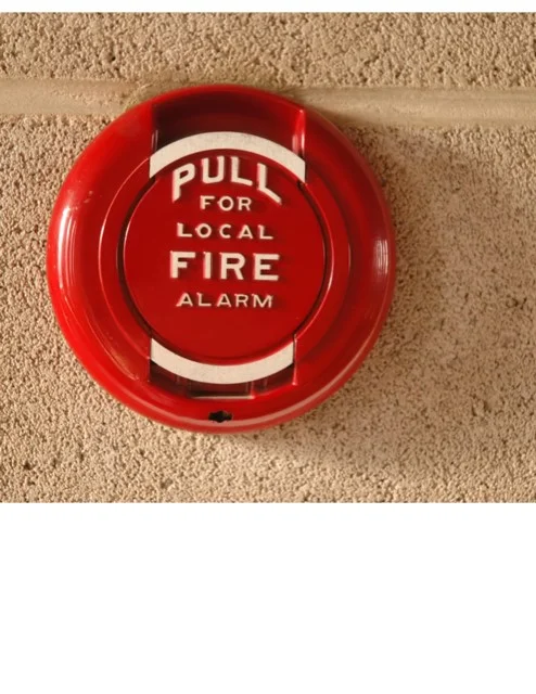 A red fire alarm on the wall of a building.
