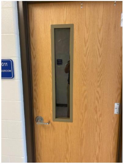 A door with a mirror on the side of it.